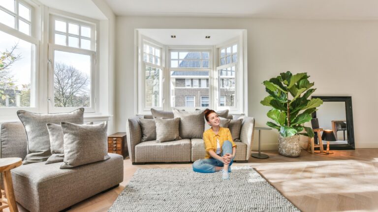 a young woman sits on the floor in living room