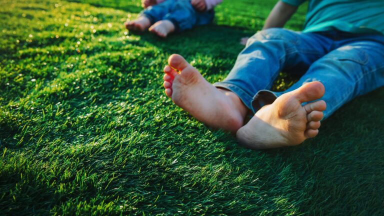 child's bare feet on grass